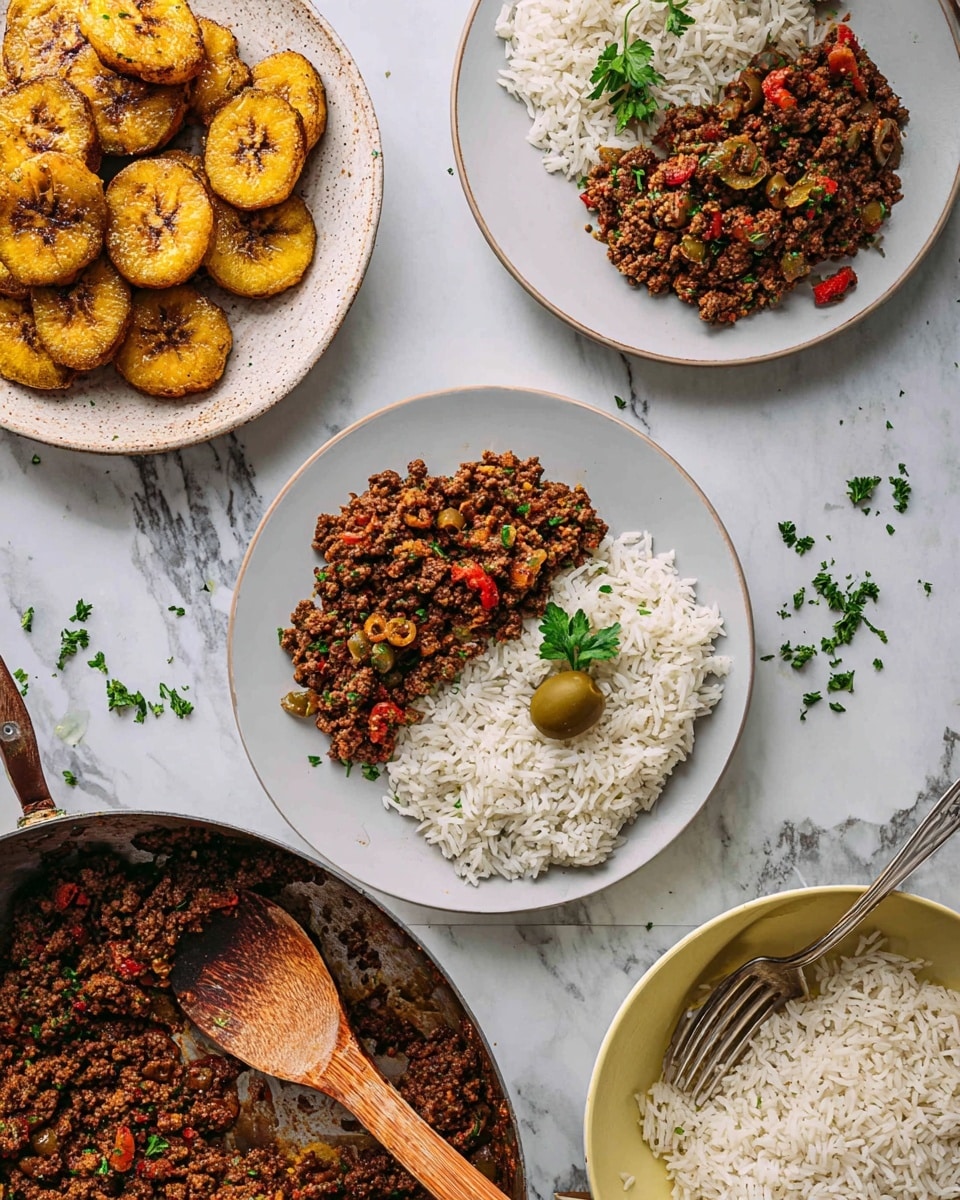 The image shows two white plates each with a neat half-and-half arrangement: a layer of fluffy white rice on one side and a thick, textured layer of cooked ground beef mixed with green olives and small red pepper pieces on the other side, topped with a small green parsley leaf. Above these plates, a white bowl is filled with golden-brown fried plantain slices sprinkled with coarse salt. At the bottom left, a large shallow pan contains more of the cooked ground beef mix, with a wooden spoon resting inside that has some of the beef and one green olive on it. To the bottom right, a light yellow bowl is filled with more white rice, with a spoon inside. Small scattered parsley pieces are visible on the white marbled surface around the dishes. Photo taken with an iphone --ar 4:5 --v 7