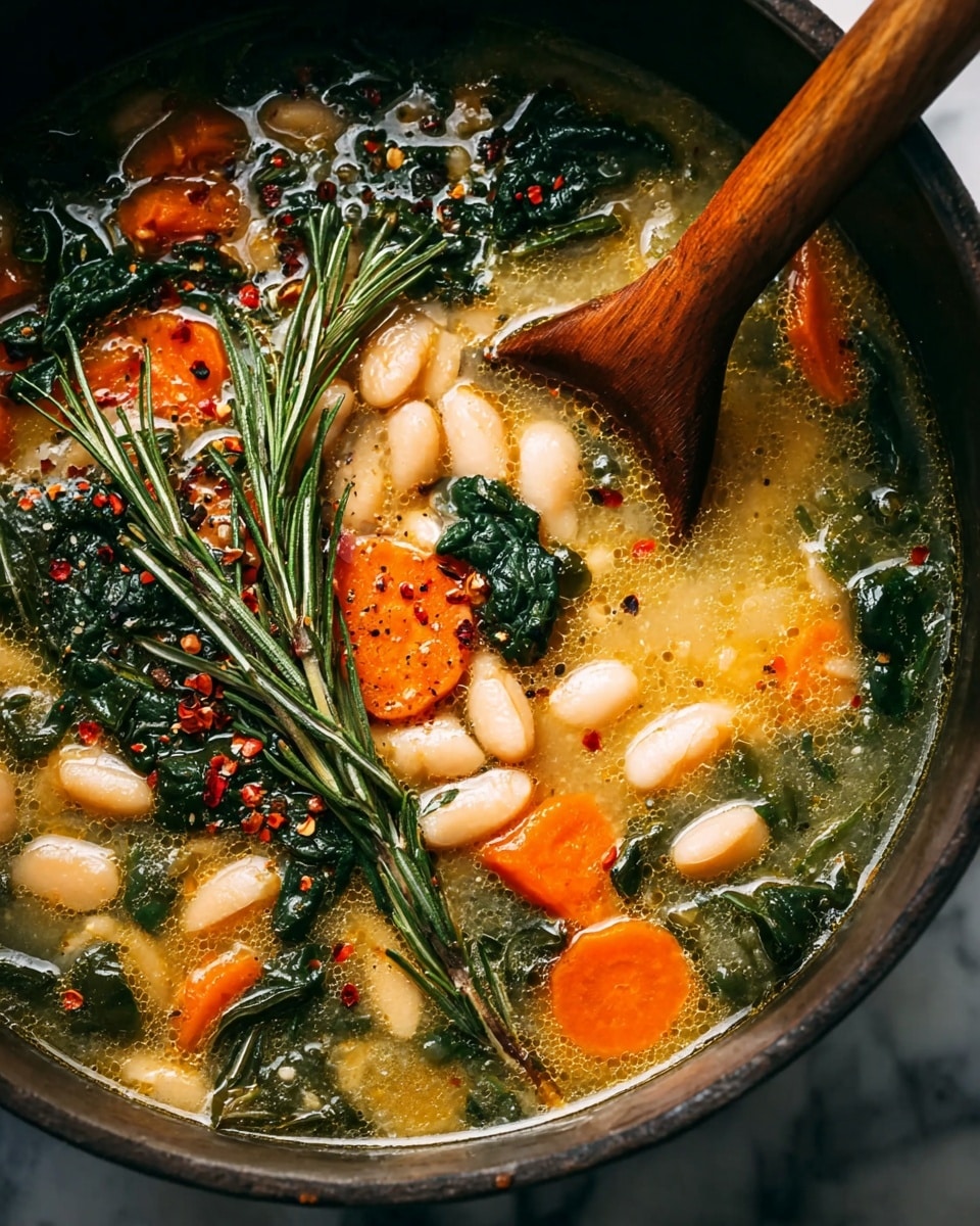 A close-up view of a soup in a dark pot, with a wooden spoon stirring inside. The soup has layers of light yellow broth with white beans, bright orange carrot slices, and dark green leafy vegetables mixed in. There are also sprigs of fresh rosemary placed on top, along with scattered crushed red pepper flakes and black pepper. The texture of the soup appears slightly oily with small bubbles, giving it a rich look. The pot sits on a white marbled surface. Photo taken with an iphone --ar 4:5 --v 7