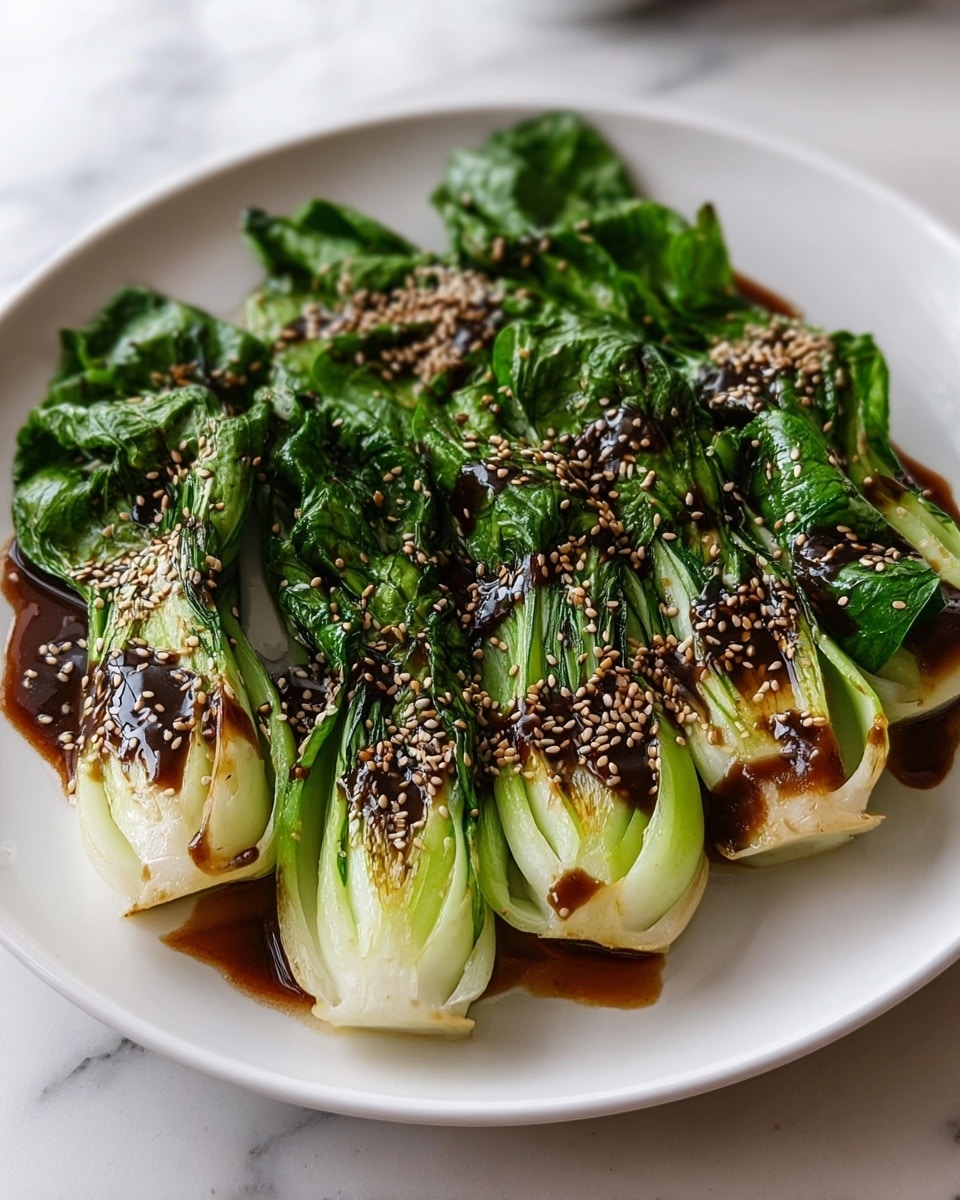 The dish shows five pieces of cooked baby bok choy arranged side by side on a white plate, placed on a white marbled surface. Each bok choy piece has a thick, pale green stem base that fades into dark green, crinkled leafy tops. A glossy, dark brown sauce is drizzled over the bok choy, pooling slightly on the plate, and sprinkled generously with light-colored sesame seeds, adding texture and contrast to the greens. The overall look is fresh and vibrant with a balance of glossy and matte textures. photo taken with an iphone --ar 4:5 --v 7