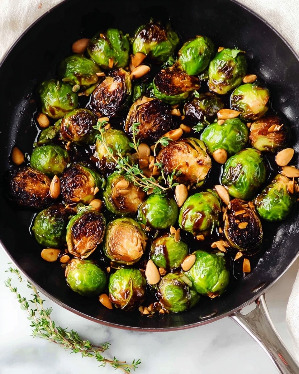 A close-up view of a black pan filled with whole and halved Brussels sprouts. The Brussels sprouts have a mix of bright green outer leaves and deeply charred, dark brown and blackened edges from roasting. Some sprouts are glistening with a shiny, dark glaze drizzled on top. The pan rests on a white marbled surface, which provides a clean contrast to the rich colors of the food. photo taken with an iphone --ar 4:5 --v 7