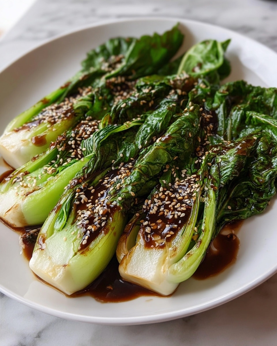 A white round plate shows four pieces of grilled bok choy arranged side by side, each cut in half lengthwise, revealing white stems and deep green leaves. The bok choy is coated with a glossy dark brown sauce, sprinkled with small, light-colored sesame seeds scattered evenly over the surface. The leaves are slightly wilted with charred spots, adding texture, while the white stems look tender and juicy. The plate is set on a white marbled surface that adds a clean and bright backdrop to the vibrant green and brown colors of the dish. photo taken with an iphone --ar 4:5 --v 7
