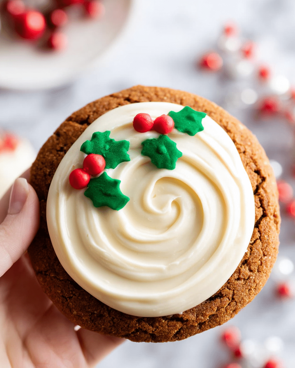 The image shows several round cookies on a metal tray lined with white parchment paper, sitting on a white marbled surface with a red and green festive cloth beneath. Each cookie has two layers: the bottom layer is a brown, rough-textured cookie base, and the top layer is a smooth, creamy white frosting spread in a thick round shape with small red and green holly-shaped decorations on top. The cookies are stacked slightly overlapping, with the closest cookie fully visible in front. A woman's hand is reaching towards the cookies from the left side. Photo taken with an iphone --ar 4:5 --v 7