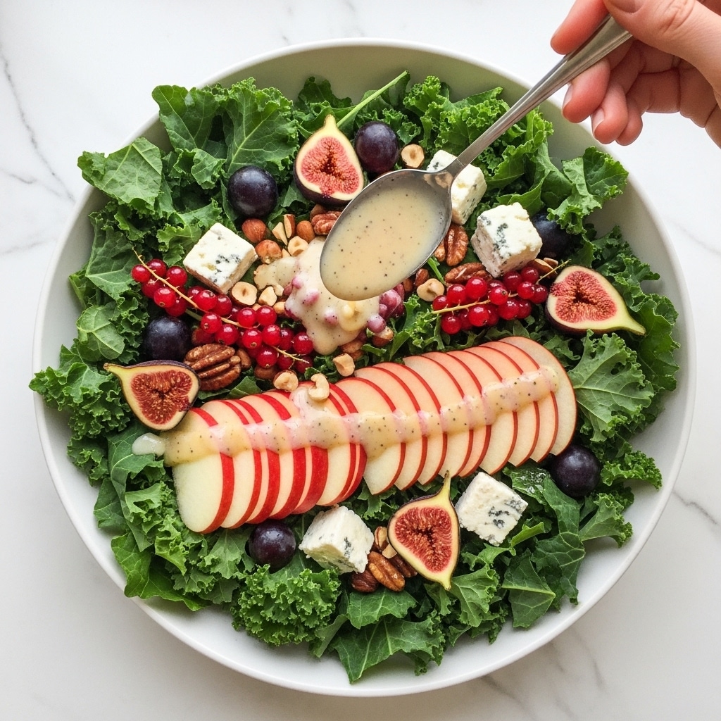The image shows a fresh green salad in a large white bowl on a white marbled surface. The bottom layer is made of leafy greens, mostly large, bright green leaves with a rough texture. On top, there are thin slices of red apple arranged neatly in a fan-like shape across the salad. Scattered among the leaves and apples are small chunks of white cheese with blue mold, pieces of figs, whole red currants, and dark purple grapes. Some nuts, possibly hazelnuts, add texture. A spoon held by a woman's hand is pouring a light-colored dressing in the center, its smooth, creamy texture catching the light as it drips slowly onto the salad. Photo taken with an iphone --ar 4:5 --v 7