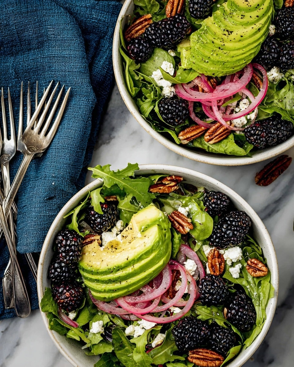 A close-up view of a fresh salad in a white bowl on a white marbled surface, showing a woman's hand pouring golden yellow dressing from a small white cup over the salad. The salad has three main layers: at the bottom, bright green leafy greens and sliced light green avocado; the middle layer includes dark black blackberries and thin rings of purple-red onion; the top layer is sprinkled with white crumbly cheese and brown pecans scattered around. The light from the side highlights the moist texture of the dressing and the fresh ingredients in the bowl. photo taken with an iphone --ar 4:5 --v 7