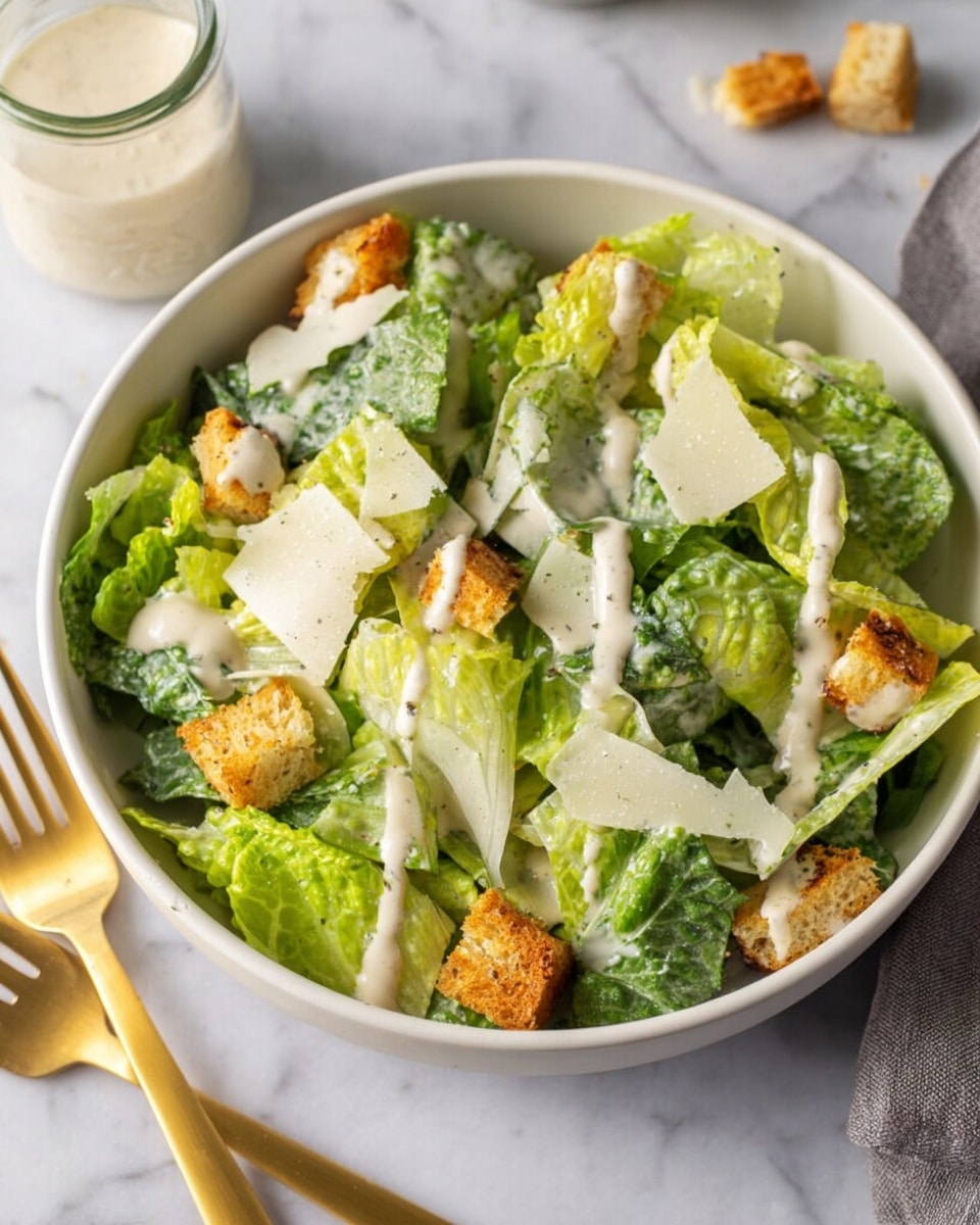 A close-up top view of a clear glass jar filled with creamy white sauce that has small bubbles and evenly scattered black pepper particles on the surface. The jar is placed on a white marbled textured surface with blurred white cheese pieces in the background. The texture of the sauce looks smooth and thick with a few small lumps. photo taken with an iphone --ar 4:5 --v 7