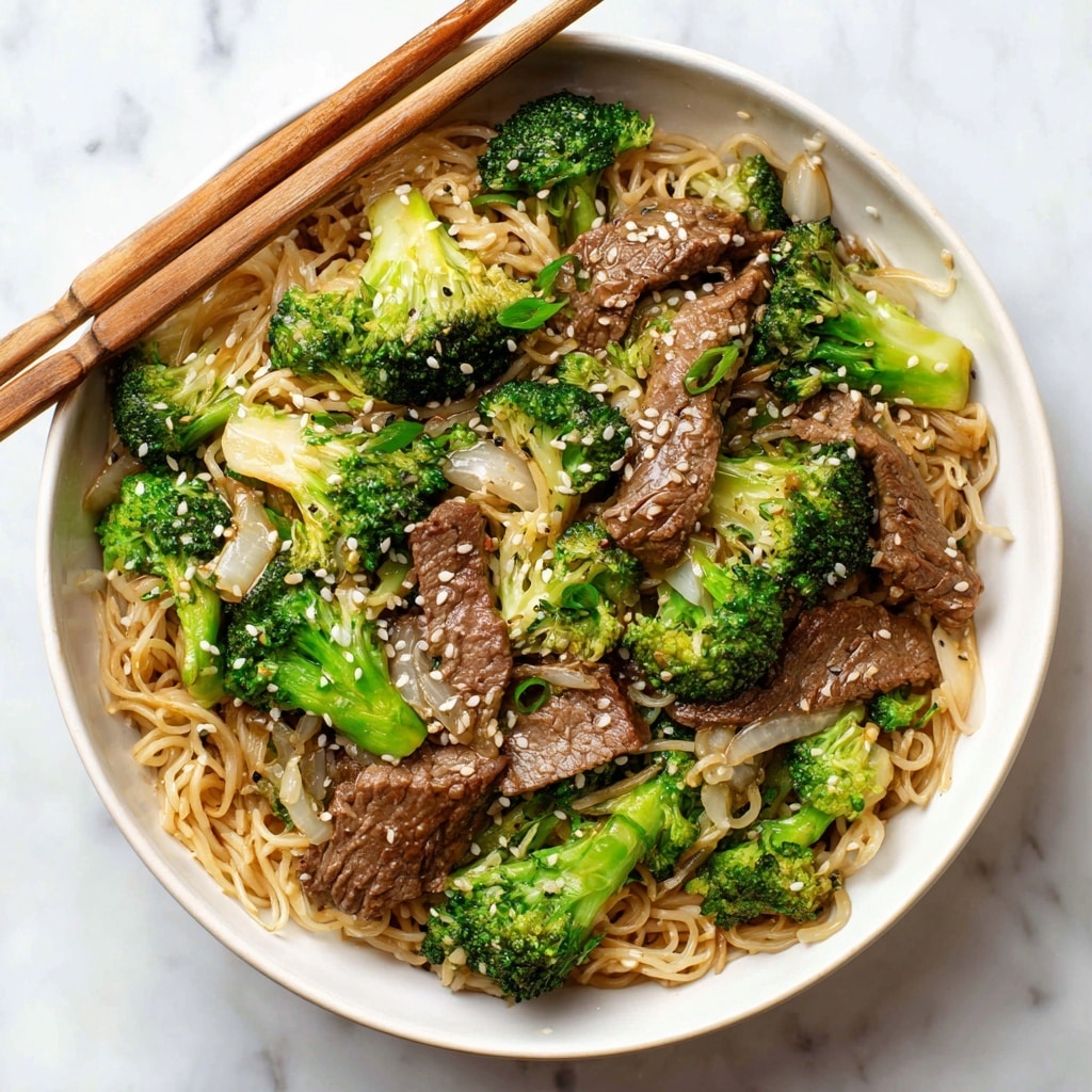 A white bowl filled with layers of stir-fried noodles as the base, light brown in color with a glossy texture. On top, even layers of cooked broccoli florets in bright green, and grilled beef slices with a slightly charred, rich brown color are spread evenly. There are also pieces of lightly cooked white onion mixed in. The dish is sprinkled with white sesame seeds all over. Across the top of the bowl, two wooden chopsticks rest horizontally. The bowl sits on a white marbled surface with a dark cloth underneath. photo taken with an iphone --ar 4:5 --v 7