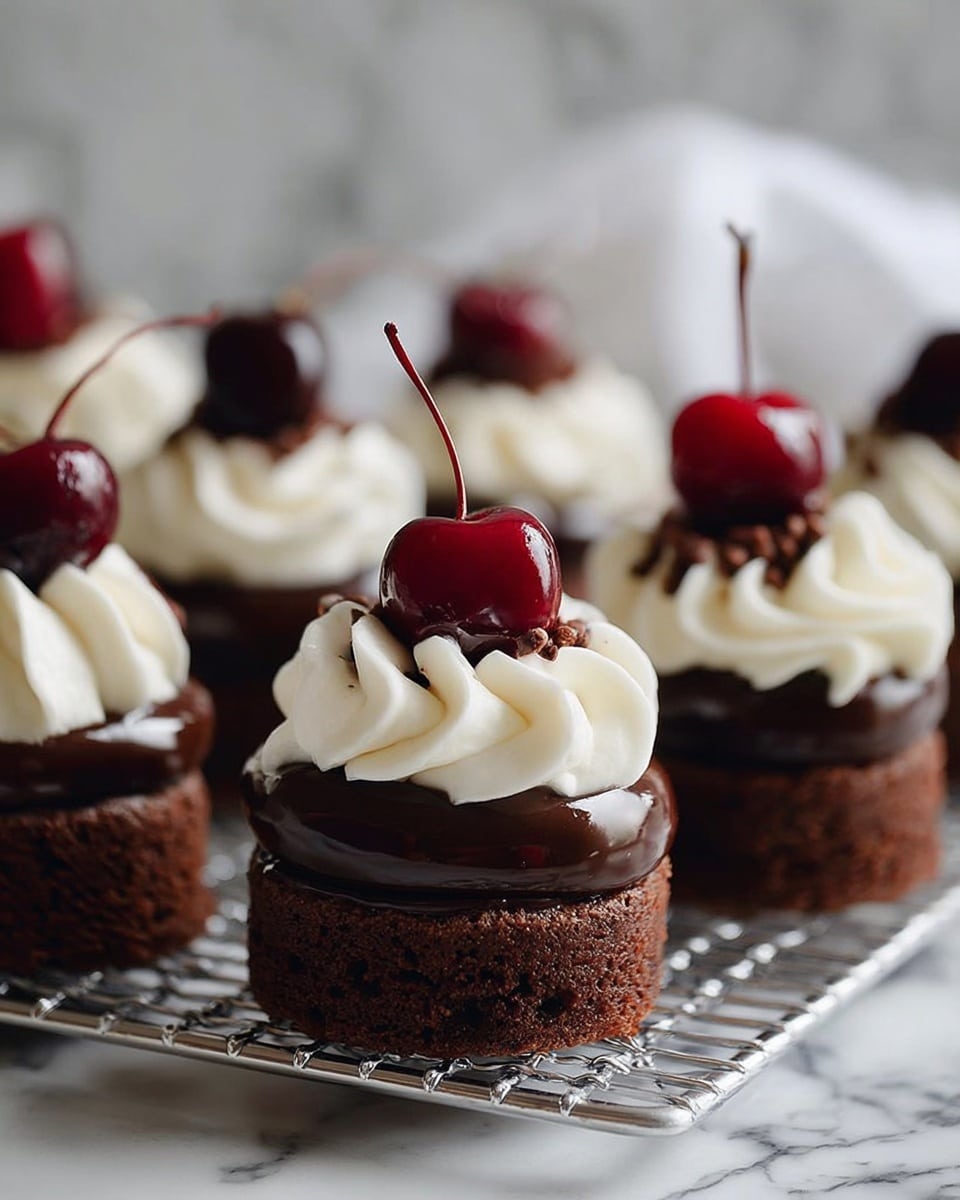 The image shows small round chocolate cakes arranged on a metal cooling rack. Each cake has three main layers: a dark brown, dense chocolate base, a smooth middle layer of milk chocolate cream, and a top layer of white whipped cream in a swirled pattern. On top of the whipped cream, a glossy dark red cherry with a thin stem sits upright, adding a bright pop of color. The background is a soft white marbled texture, keeping the focus on the cakes. photo taken with an iphone --ar 4:5 --v 7