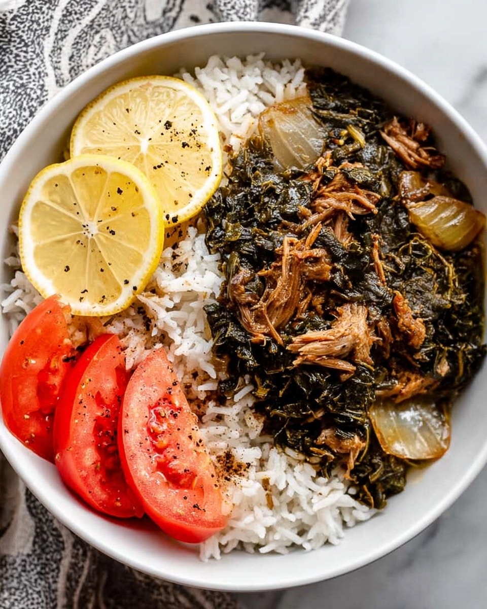 A white bowl filled half with white rice mixed with toasted brown bits sits at the bottom layer, topped with a thick layer of cooked dark green leafy vegetables mixed with shredded brownish meat and translucent cooked onion pieces. On one side of the bowl, there are two bright yellow lemon slices placed on the rice, and on the opposite side, there are three wedge-cut tomato slices with red color and a sprinkling of black pepper. The bowl rests on a white marbled surface with a cloth underneath. Photo taken with an iphone --ar 4:5 --v 7
