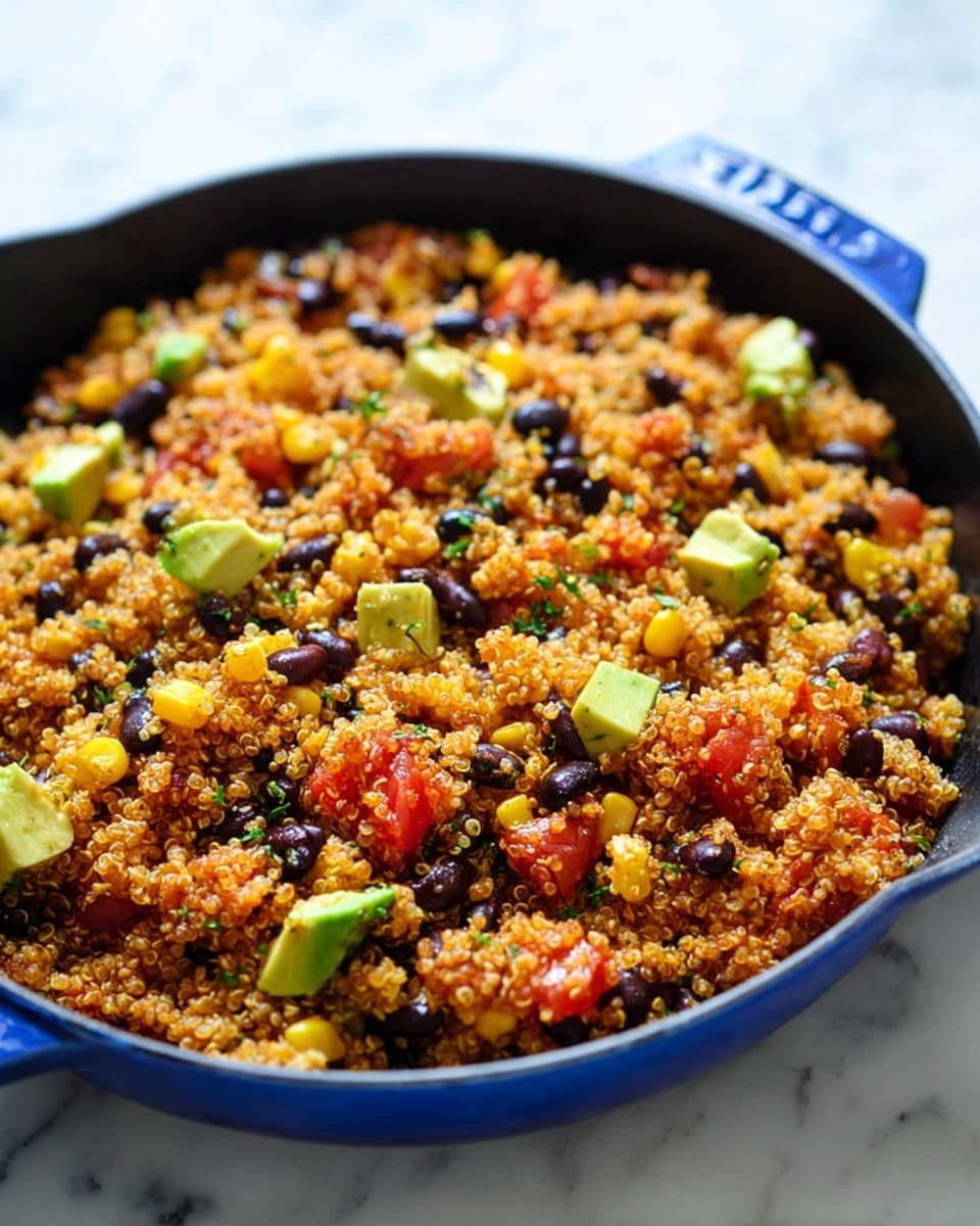 The image shows a close-up of a colorful quinoa salad mixed with black beans, yellow corn, diced red tomatoes, and small cubes of green avocado. The quinoa grains are light brown and fluffy, forming the base layer throughout the dish. Scattered on top are the bright yellow corn kernels and dark purple-black beans, adding contrast and texture. Small chunks of red tomatoes and green avocado pieces are mixed in evenly, bringing a fresh look with hints of chopped herbs sprinkled throughout. A wooden spoon with a smooth light wood handle scoops a portion of the salad from the center. The background is a white marbled texture, making the colors of the dish stand out vividly. Photo taken with an iphone --ar 4:5 --v 7